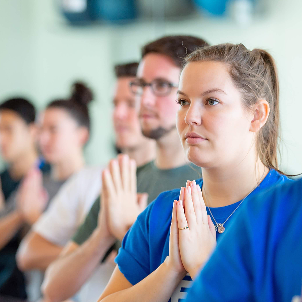 students participating in a yoga class.