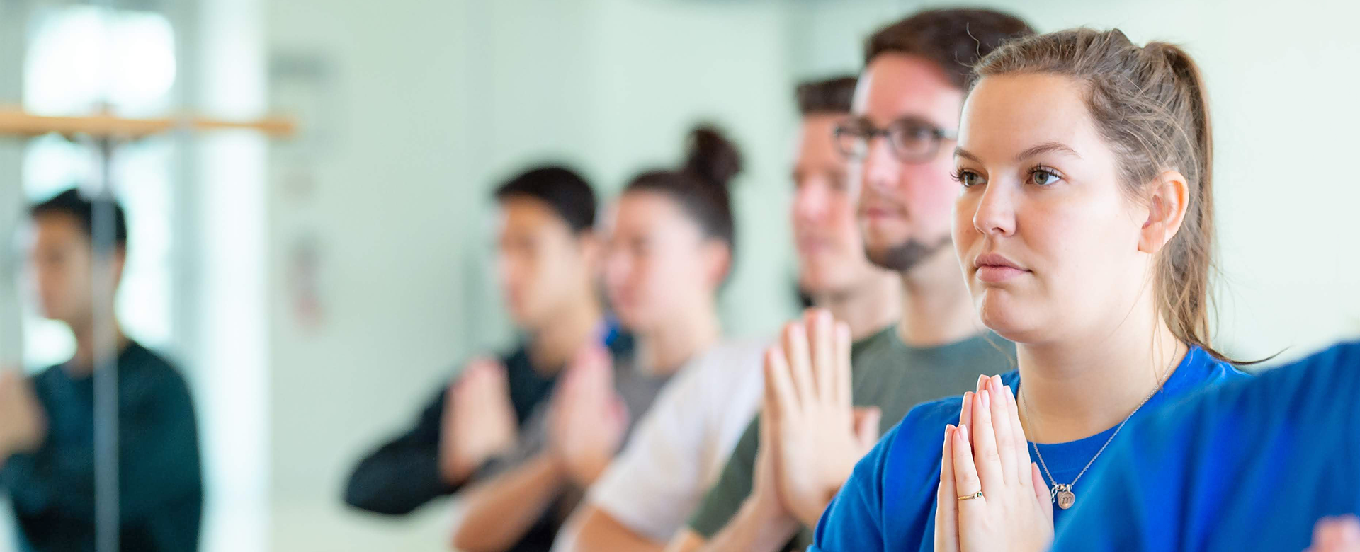 students participating in a yoga class.